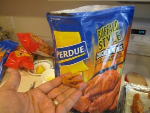 Photograph of Perdue brand buffalo wings with a chicken foot.