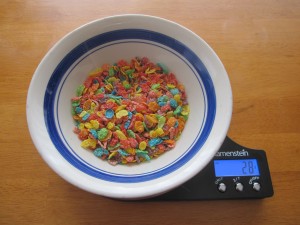 Photograph of Fruity Pebbles in a bowl on a food scale.