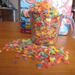 Photograph of Fruity Pebbles overflowing a small measuring cup.