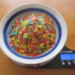 Photograph of Fruity Pebbles in a bowl on a food scale.